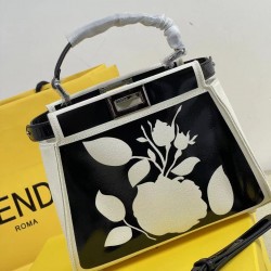 Upgraded Cowhide Lot 390 with Box Fendi's new iconic Peekaboo pouch in black canvas and patent leather is engraved with a rose motif displaying a natural canvas backing and is adorned with a signature twist lock on both sides.Canvas liningTwo compartments