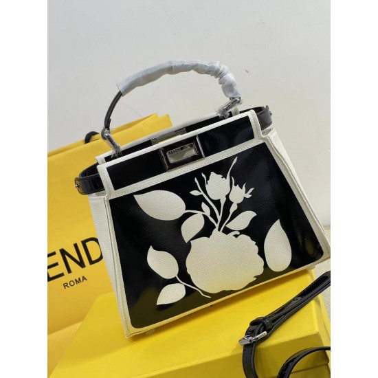 Upgraded Cowhide Lot 390 with Box Fendi's new iconic Peekaboo pouch in black canvas and patent leather is engraved with a rose motif displaying a natural canvas backing and is adorned with a signature twist lock on both sides.Canvas liningTwo compartments