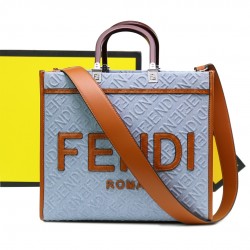 Lot 330FEND1 Sunshine medium tote bag in denim with FENDI Mirror pattern all over brown rigid leather handles decorated with FENDI ROMA features spacious lined interior compartments leather silhouette and gold finish metal pieces with two carry handles an