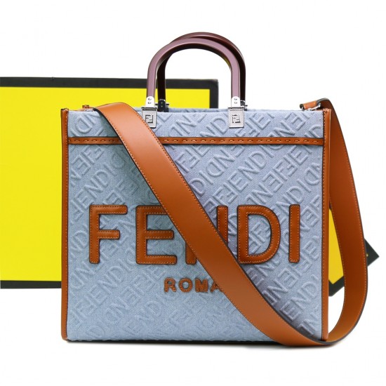 Lot 330FEND1 Sunshine medium tote bag in denim with FENDI Mirror pattern all over brown rigid leather handles decorated with FENDI ROMA features spacious lined interior compartments leather silhouette and gold finish metal pieces with two carry handles an