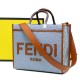 Lot 330FEND1 Sunshine medium tote bag in denim with FENDI Mirror pattern all over brown rigid leather handles decorated with FENDI ROMA features spacious lined interior compartments leather silhouette and gold finish metal pieces with two carry handles an