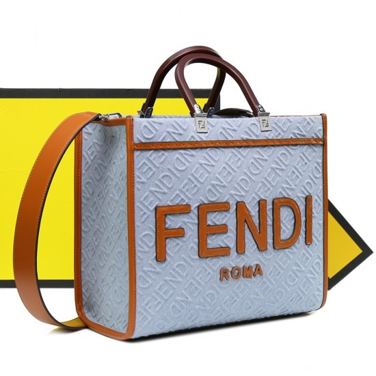 Lot 330FEND1 Sunshine medium tote bag in denim with FENDI Mirror pattern all over brown rigid leather handles decorated with FENDI ROMA features spacious lined interior compartments leather silhouette and gold finish metal pieces with two carry handles an
