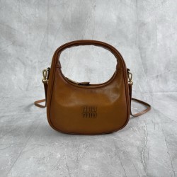 P6805BC125 Cognac soft cowhide leather with an aged effect gives the Wander a new modern elegance combining a refined silhouette with the bold experimental spirit of Miu Miu lcons Removable shoulder strap Gold-tone hardware Zipper closure Strap lining Eng