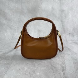 P6805BC125 Cognac soft cowhide leather with an aged effect gives the Wander a new modern elegance combining a refined silhouette with the bold experimental spirit of Miu Miu lcons Removable shoulder strap Gold-tone hardware Zipper closure Strap lining Eng