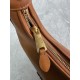 P6805BC125 Cognac soft cowhide leather with an aged effect gives the Wander a new modern elegance combining a refined silhouette with the bold experimental spirit of Miu Miu lcons Removable shoulder strap Gold-tone hardware Zipper closure Strap lining Eng