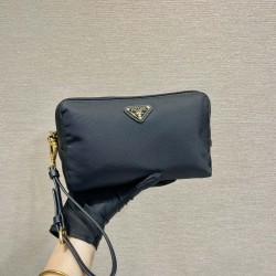 P220 New Clutch 1NS693 Gold Hardware This clutch is made of imported nylon fabric with a white lacquered triangular logo decorating the simple lines Open the bag to reveal a zippered interior pocket Removable leather wristlet for both men and women Lightw